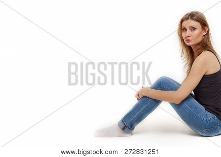 Attractive Young Caucasian Woman With Dark Brown Hair And Eyes Sitting Back To The Left Side Of Pict