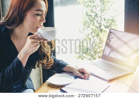 Young Girl Is Drinking Coffee At Coffee Shop,businessmen Are Talking About Work On A Coffee Shop.