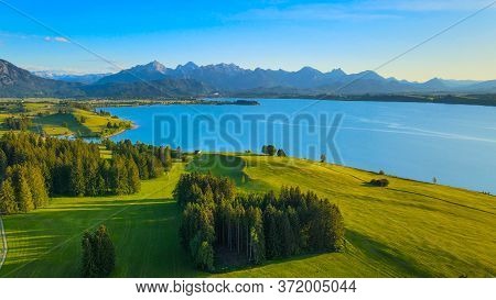 Aerial View Over Lake Forggensee At The City Of Fuessen In Bavaria Germany