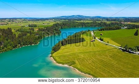 Aerial View Over Lake Forggensee At The City Of Fuessen In Bavaria Germany