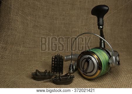 Fishing, Carp Reel With Fishing Linel On The Background Of Burlap . Burlap