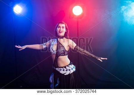 Girl Dancing Belly Dance, Fusion Or Tribal. A Woman In A Beautiful Costume Demonstrates Charming And