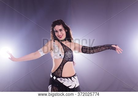 Girl Dancing Belly Dance, Fusion Or Tribal. A Woman In A Beautiful Costume Demonstrates Charming And