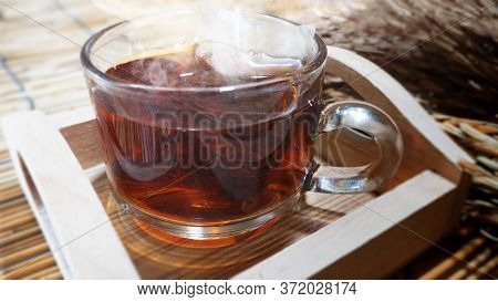Hot Tea In Clear Glass On A Woven Wooden Floor