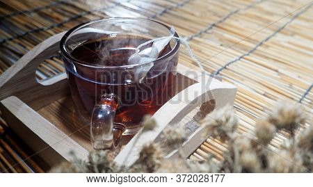 Hot Tea In Clear Glass On A Woven Wooden Floor