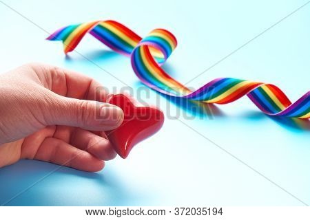 Hand Holding Heart And Rainbow Ribbon, Symbols Of Public Support For Doctors, Nurses, Medical Stuff 