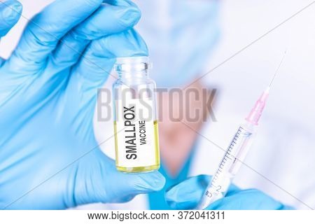 Text Smallpox Vaccine Of Is Written On A Bottle With The Background Of A Doctor With A Syringe In A 