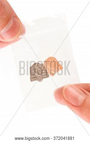 Mdma Ecstasy Pills In Plastic Bag Over White.