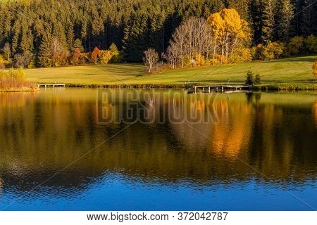 autumn pond under the mountains, Murau district,
Styria, Austria
