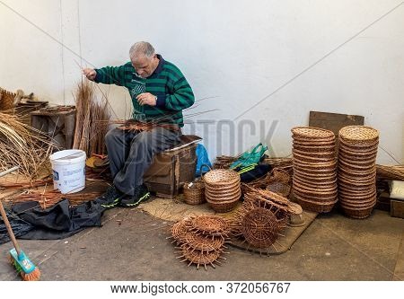Camacha, Madeira, Portugal - April 19, 2018: A Basket Weaver At Work In The Factory Shop In Camacha 