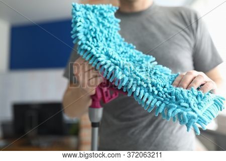 Close-up Of Male Person Holding Fluffy Blue Rag For Floor Cleaning. Equipment For Wet Clean. Cleanin