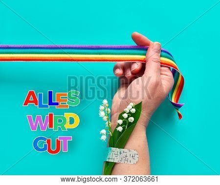 Text Alles Wird Gut In German Means Everything Will Be Well In English. Hand Hold Rainbow Ribbon. Ba