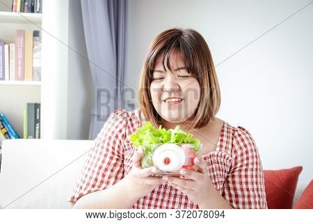 Fat Asian Women Carry A Cup Of Salad Greens To Eat To Lose Weight And Make Them Healthy. The Concept