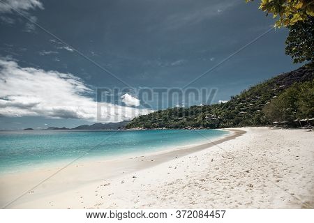 Beautiful Seychelles Island, Ocean Shore With White Sand And Blue Sky