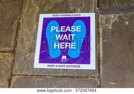 Chester, Uk: Jun 14, 2020: A Customised Social Distancing Marker On The Pavement Has Been Branded By