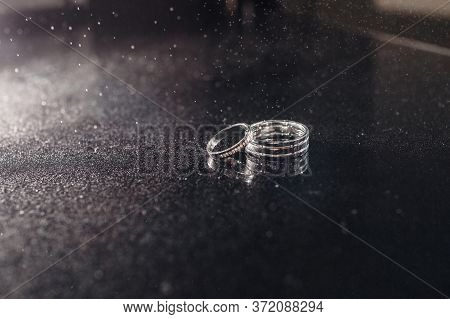 Gold Closeup On Black Background. Accessories. Jewellery Gems. Acessories. Wedding Rings