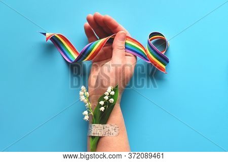 Thank You Doctors And Nurses Rainbow Ribbon In Hand Of Mature Woman With Chamomile Flower And Grass 