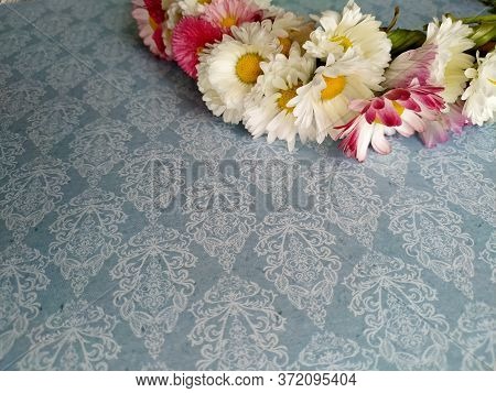 Wreath Of Daisies On A Steel Blue Background. Selective Focus