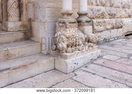 Jerusalem, Israel, June 13, 2020 : Lying Stone Lion Supporting Pillars At The Entrance To Lutheran C