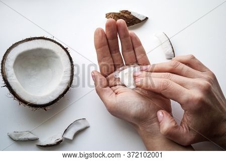Woman Smears Her Hands With Natural Cream. Female Hands Close-up Top View. Organic Cosmetics With Co
