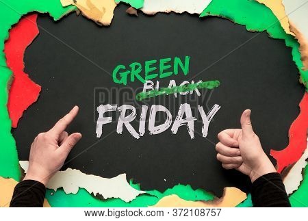 Green Friday, Burnt Frame With Burned Color Paper. Hands Showing Ok Sign And Pointing Index Finger.t