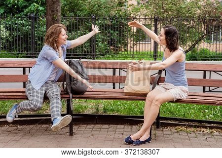 Friends Meet Each Other In The Park. Greeting Girls With Social Distancing