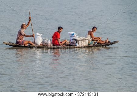Rupsa, Bangladesh - November 15, 2016: Three Men On A Small Conoe On Rupsa River, Bangladesh