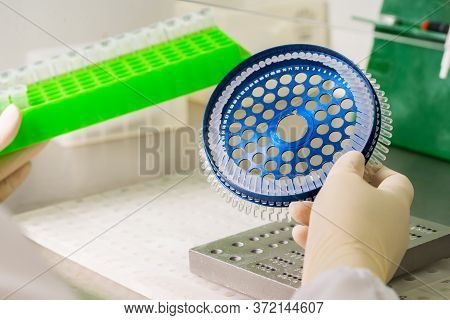 Dna Analysis On Medical Devices In The Hands Of A Physician With Gloves In The Process Of Installati