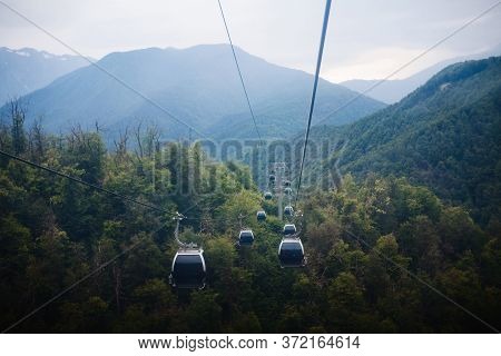 Cable Car To The Top Of The Mountain, Many Cabs Moving Down.