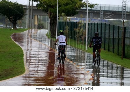 Salvador, Bahia / Brazil - April 2, 2019: People Are Seen Riding Their Bikes In The Rainy Season On 