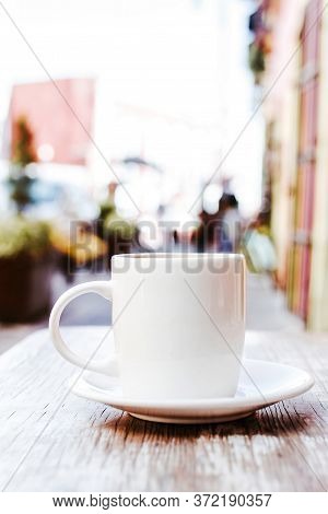 Cup Of Coffee In The Street Or Outdoors At Coffee Shop Or Cafe With Blurred Background