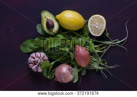 A Avocado With Arugula, Lemon, Garlic And Onions