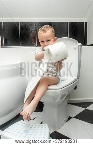 Excited Two Year Old Toddler Sitting On Toilet. Cute Kid Potty Training For Pee And Poo. Caucasian L