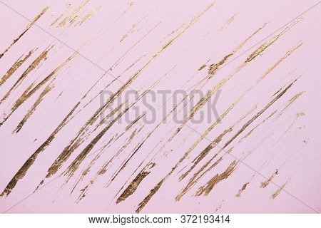 Diagonal Gold Potal Brush Strokes On Pink Pastel Paper Background Or Texture