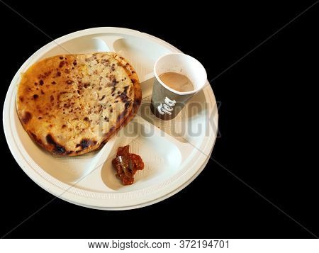 Paratha Chai With Pickle In Plate Morning Breakfast In India Over Dark Black Background With Space F