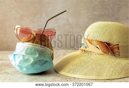Coconut In Sunglasses And Medical Masks And Straw Beach Hat. Sea Vacation During Coronavirus Pandemi