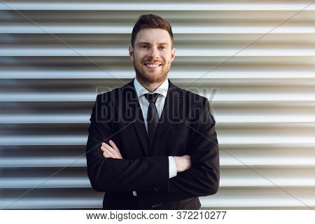 Businessman Hands Crossed Smilling On Grey Background. Business Man Smilling On Sun
