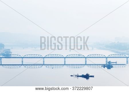 Pyongyang, Dpr Korea. North Korea. Taedong Bridge Over Taedong River In The Morning Fog. View Facing