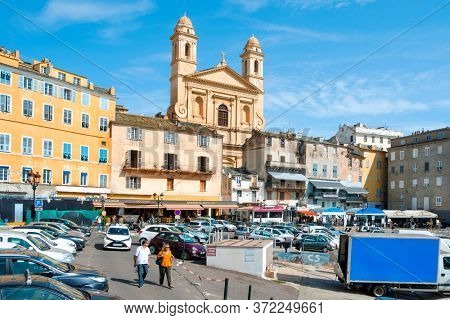 BASTIA, FRANCE - SEPTEMBER 16, 2018: A view of the Vieux Port, the Old Port of Bastia, in Corsica, France, highlighting the Saint-Jean-Baptiste Church with its characteristic twin bell towers
