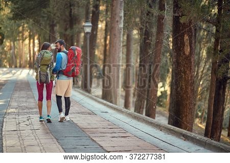young couple hiking in beautiful nature in italy, toskana
