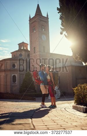 young adult couple is abut to kiss at sunset in italy, toskana