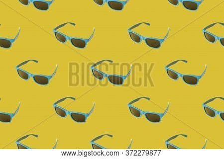 Pattern With Summer Blue Sunglasses On A Yellow Background With Black Lenses. Summer Minimalism