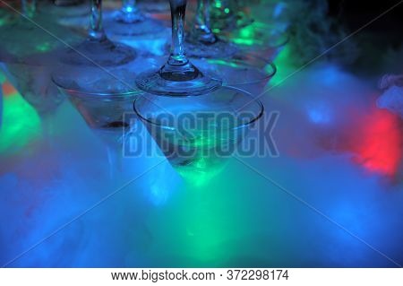 Glasses Of Champagne And Lights And Smoke From Dry Ice