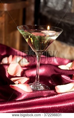 Floating Candles With Pink Rose Petals On A Wedding Reception Table.