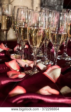 Glasses With Champagne On The Red Tablecloth