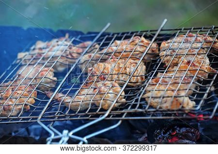 Skewer Chicken Pieces Roasting On The Grill And Smoke