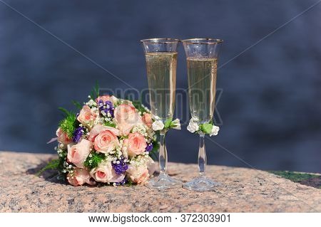 Two Glasses Of Champagne And A Beautiful Tender Festive Wedding Bouquet Of Flowers