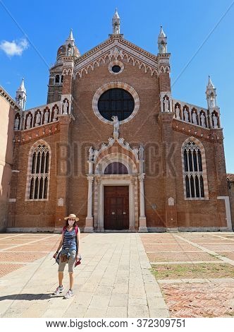 Beautiful Woman With Hat And Surgical Mask During The Trip To Venice In Front Of The Church Called M