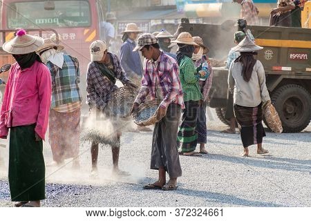 Bago, Myanmar - December 10, 2016: Local Road Workers Building A Macadam Road.