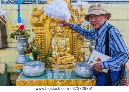 Yangon, Myanmar - December 15, 2016: Local Man Performing A Ritual At Botataung Paya Pagoda In Yango